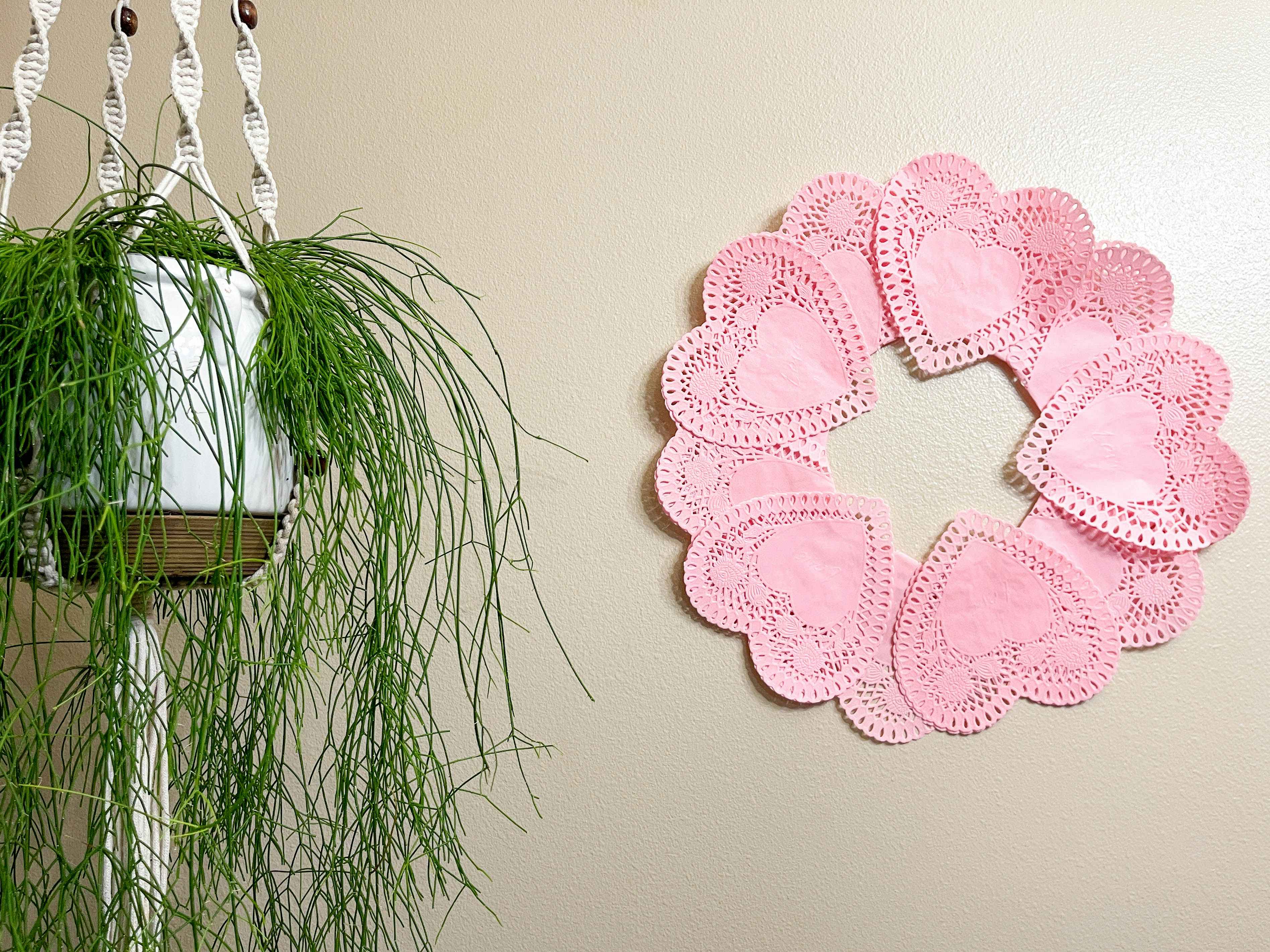 a heart paper doilies wreath on a wall 