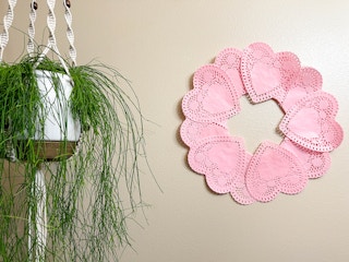 a heart paper doilies wreath on a wall