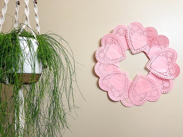 a heart paper doilies wreath on a wall 