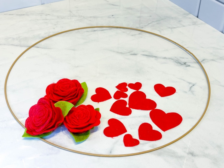 felt hearts and roses next to a hoop 