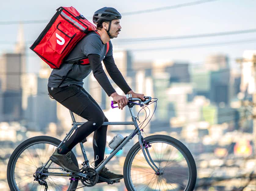 doordash delivery person riding bike in city