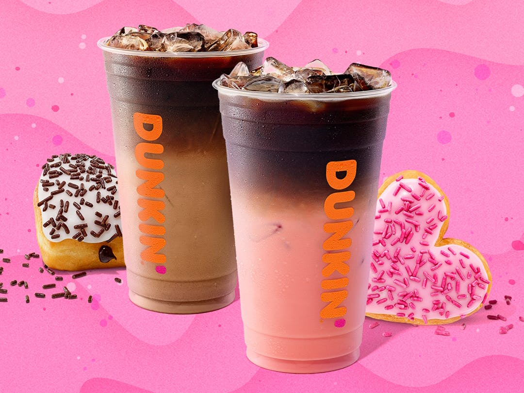 Some Dunkin drinks and heart-shaped doughnuts on a pink background
