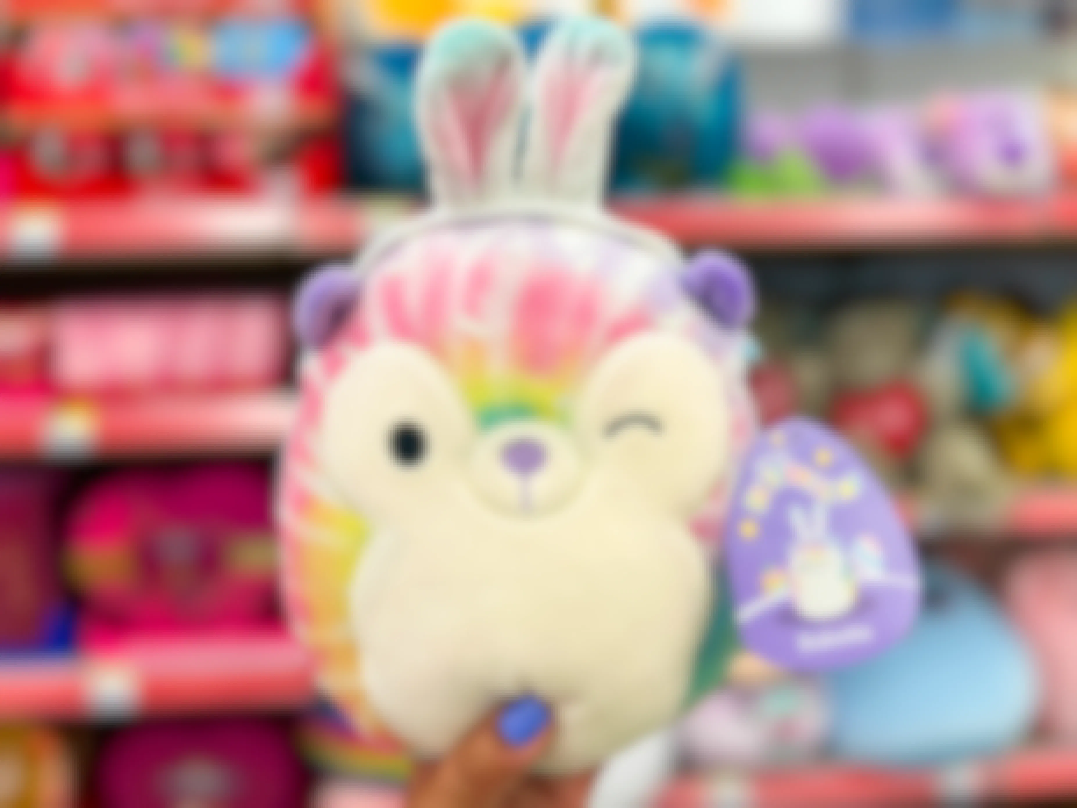 Someone holding up an Easter Babette Squishmallow in Walgreens