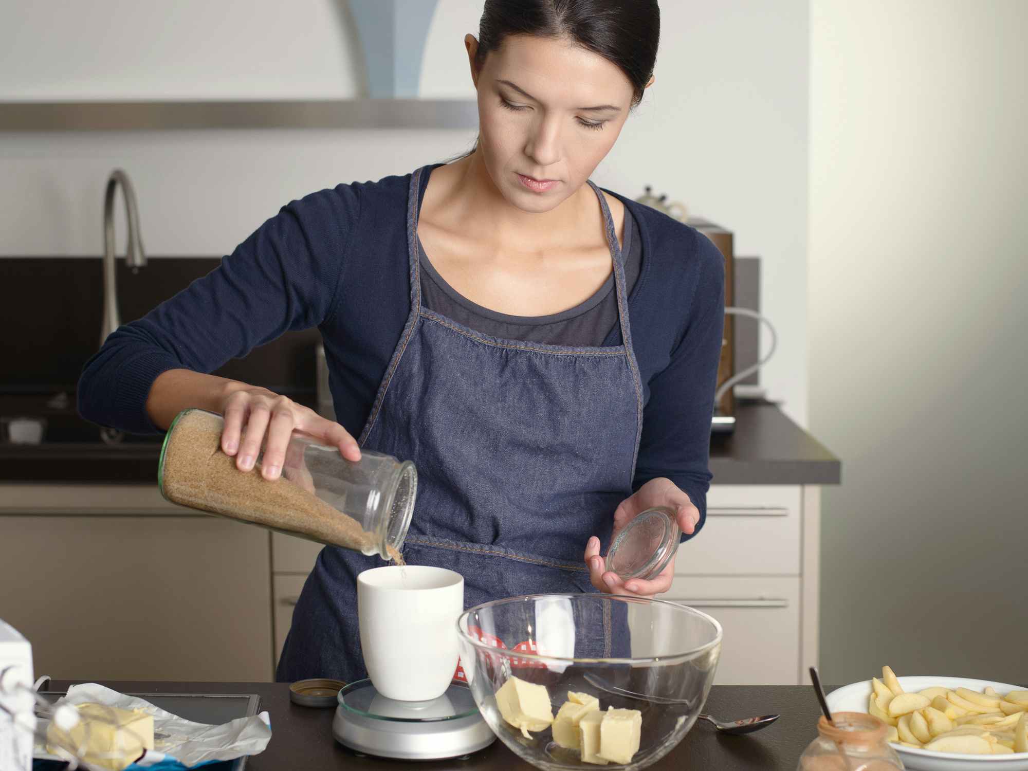 person surrounded by ingredients baking in the kitchen