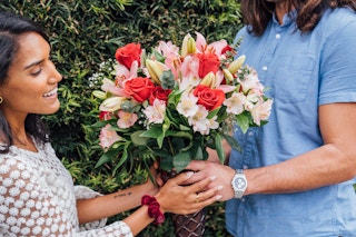 A beautiful bouquet of flowers being handed to someone