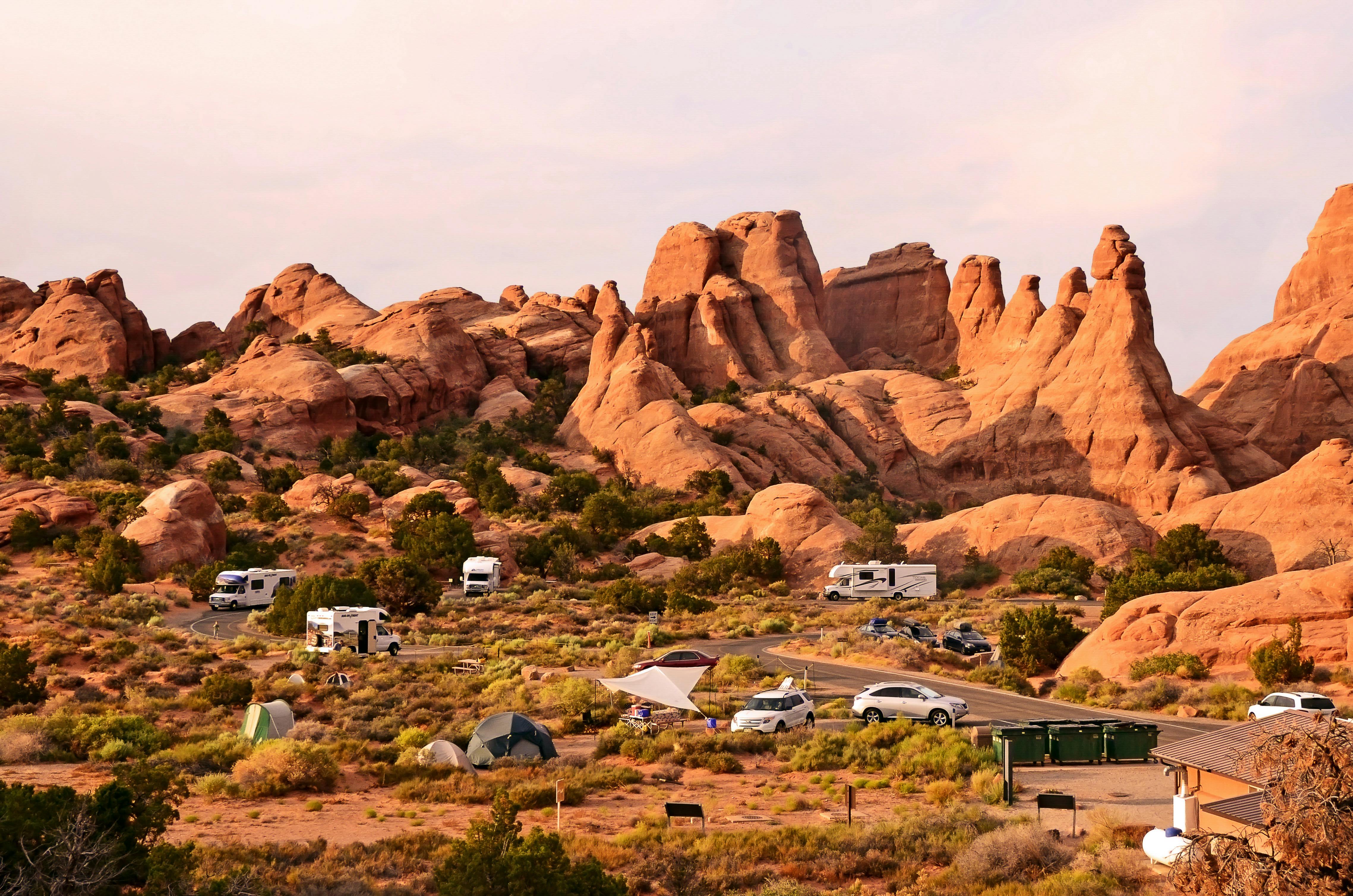 A handful of RVs and tents posted up across a desert campground