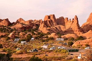 A handful of RVs and tents posted up across a desert campground