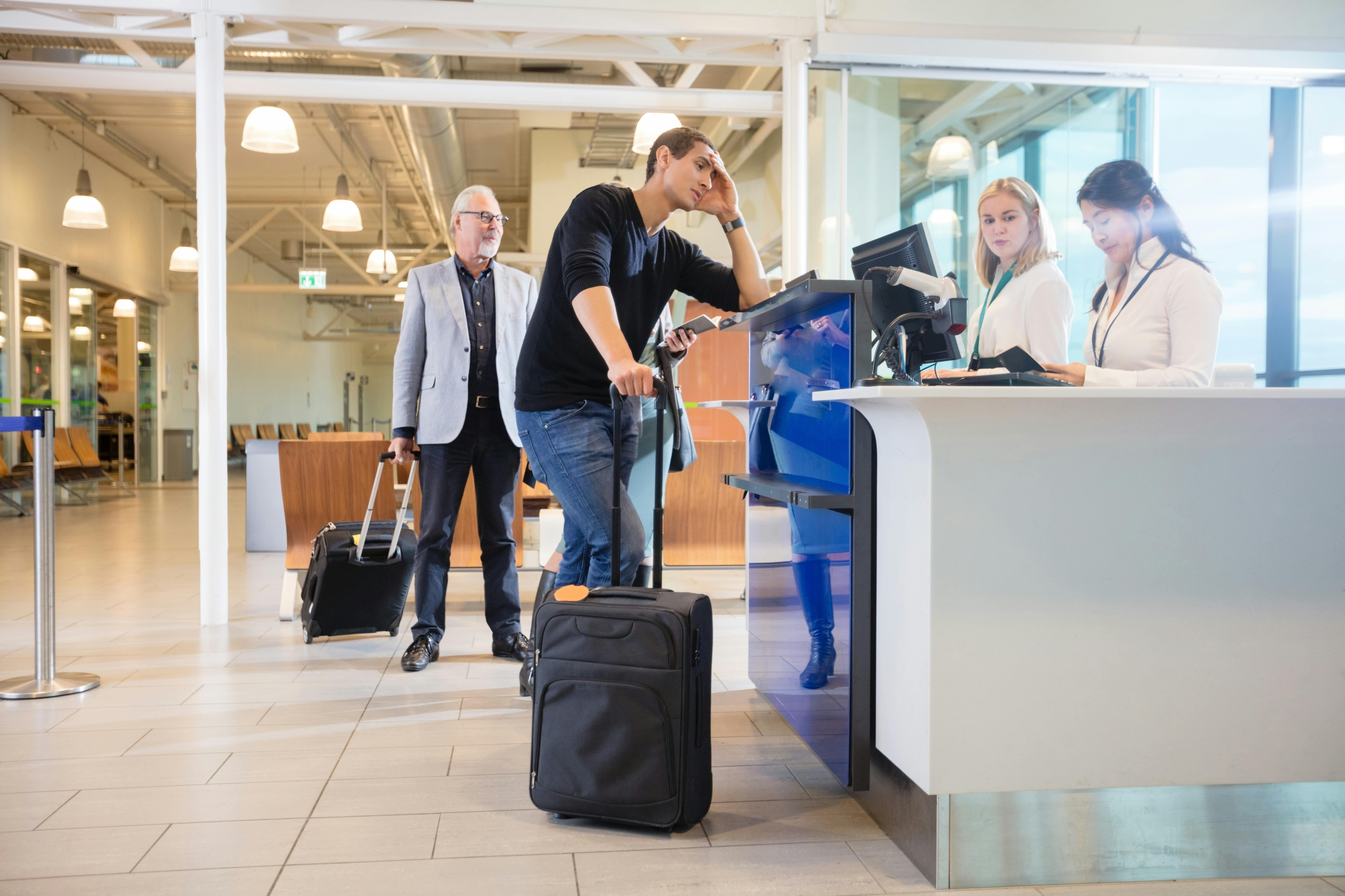 Person frustrated at airport check in desk
