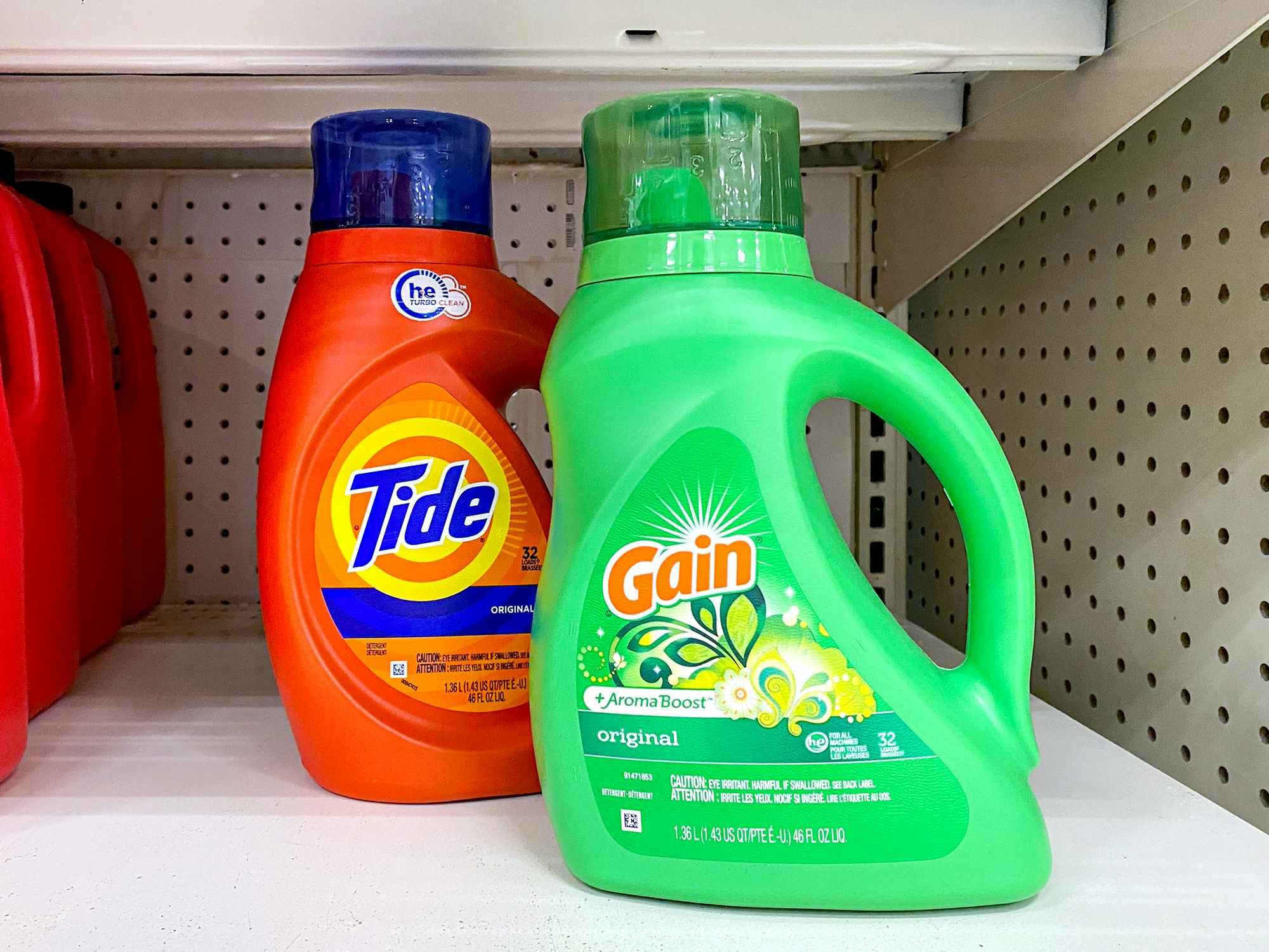 bottles of tide and gain original laundry detergents on store shelf