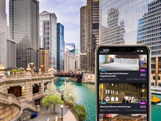 A view of the Chicago river with a smartphone infront of it showing hotel listings on HotelTonight for under $100