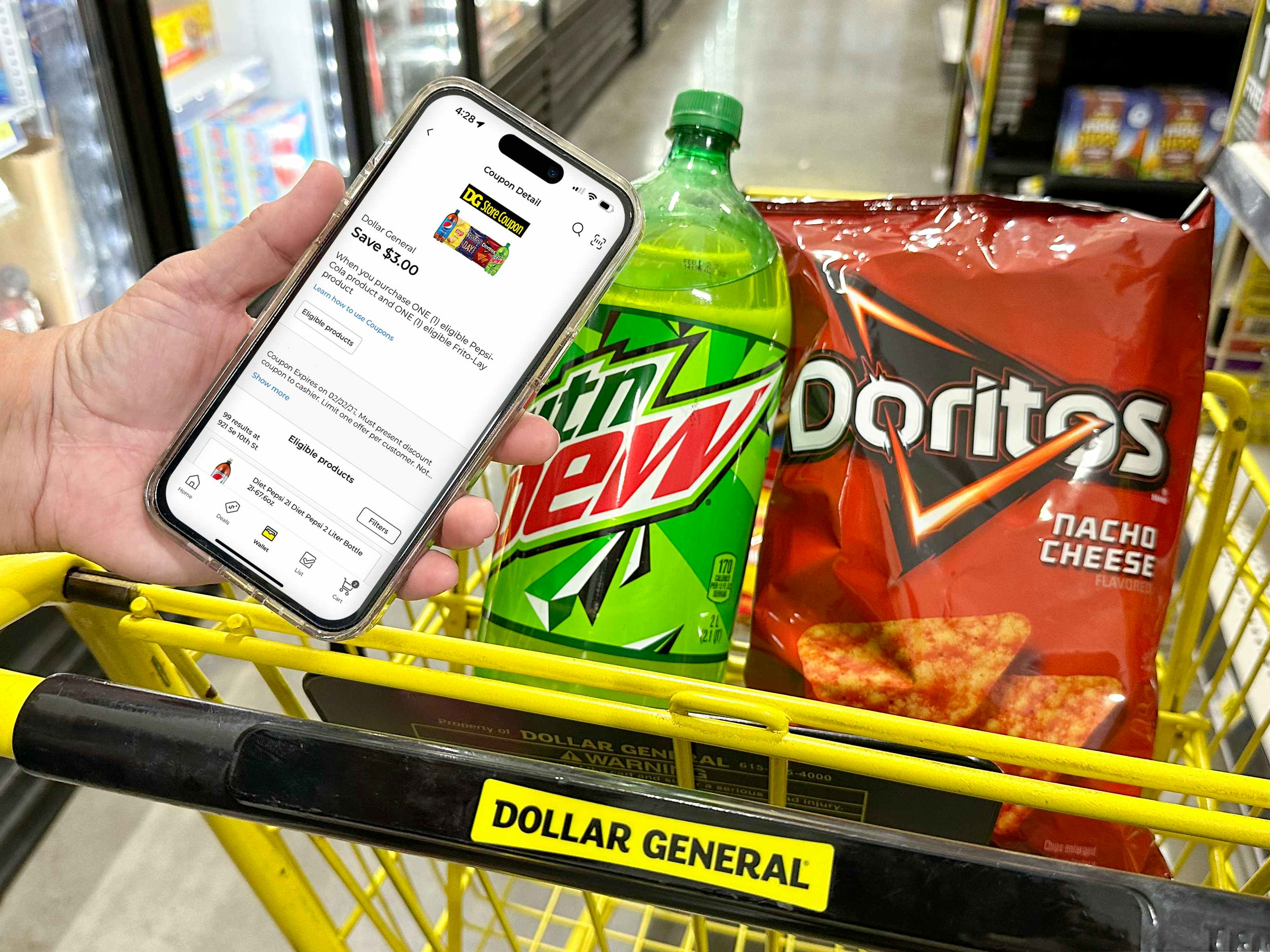 Someone holding up a phone displaying a digital coupon on the Dollar General app next to a cart with products