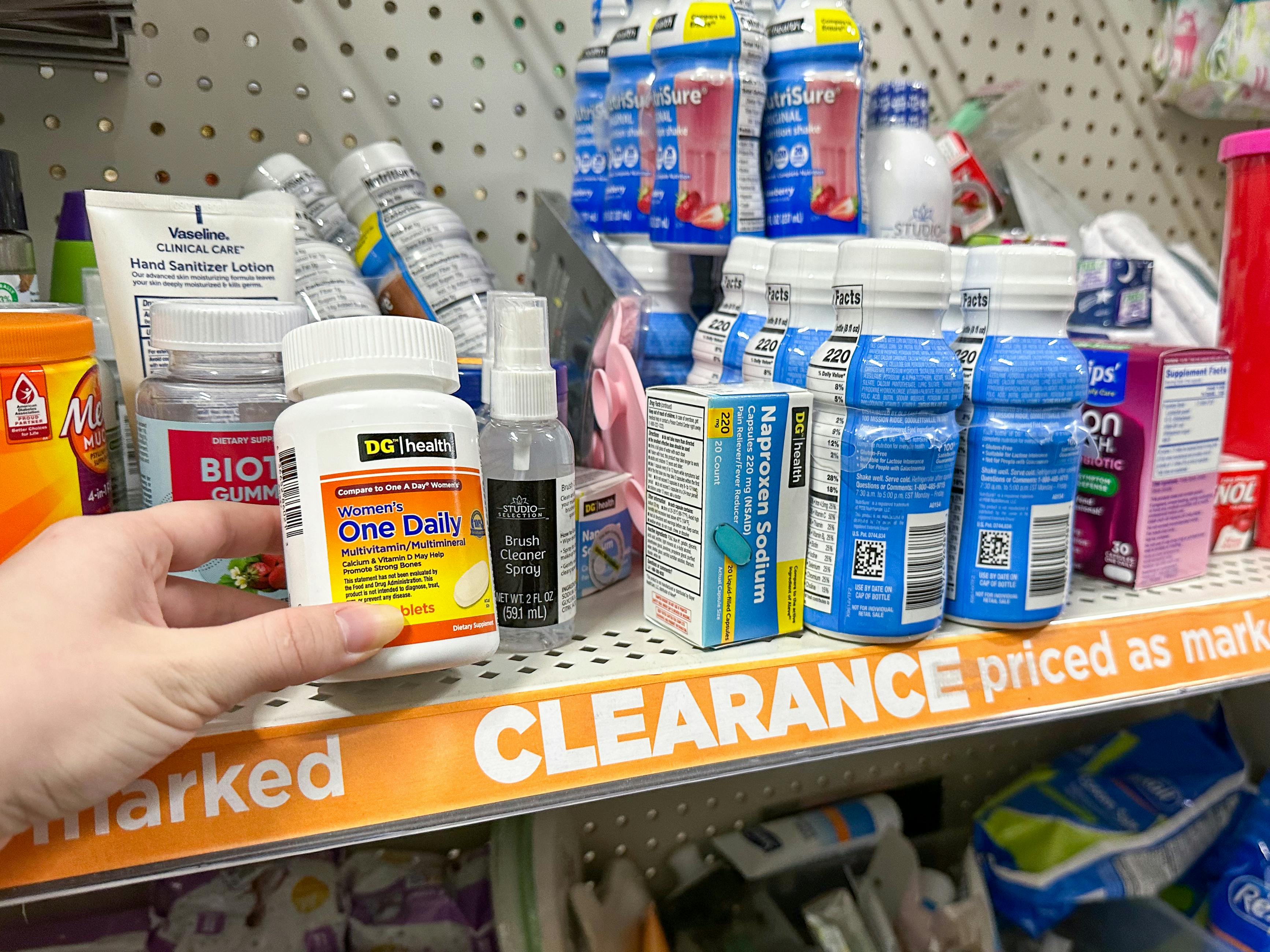 Someone taking an item from the Dollar General clearance shelf