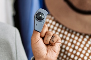 Someone holding up a security tag for clothing