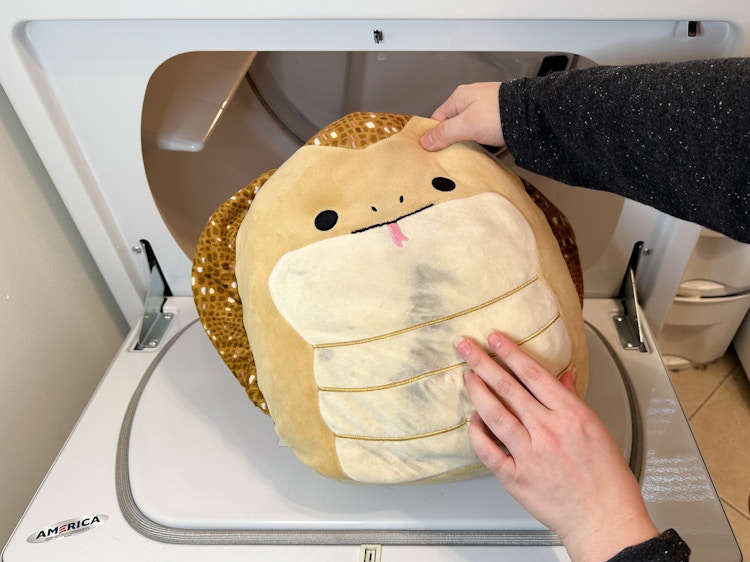 A Squishmallow that has been through the drier with a burn on its tummy
