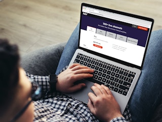 person on laptop looking at fubo streaming service free trial