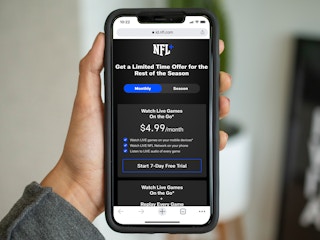 person holding iphone with screenshot of nfl+ promotion