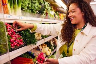 Instacart shopper picking up produce at a grocery store
