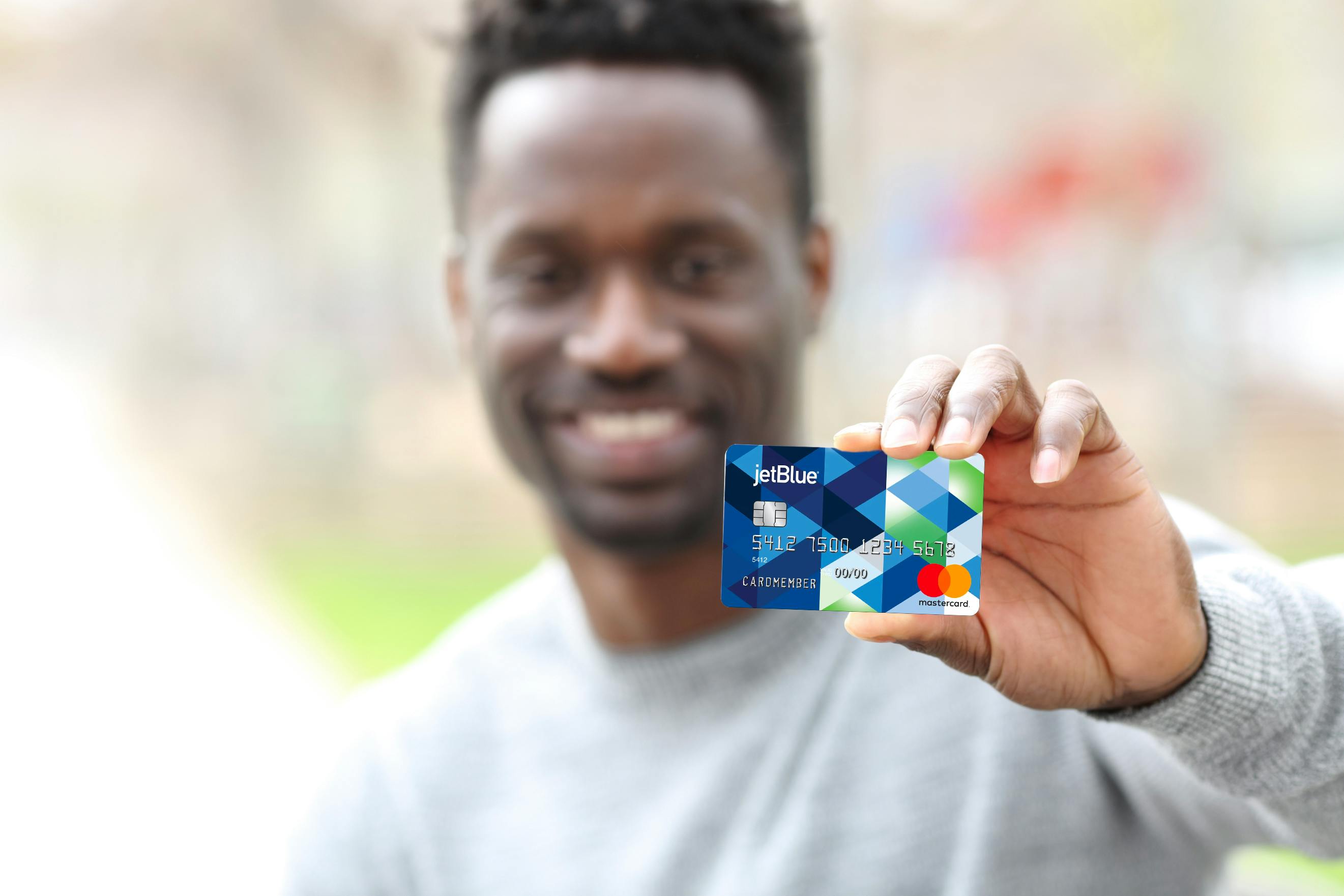 Man showing his jet blue credit card