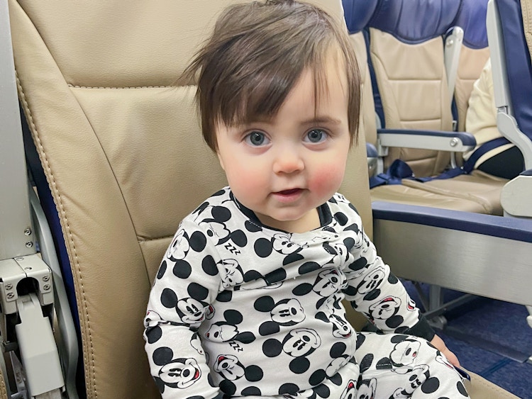 a baby sitting in a seat on an airplane