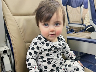 a baby sitting in a seat on an airplane
