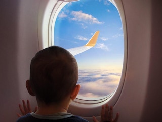 a child looking out of an airplane window