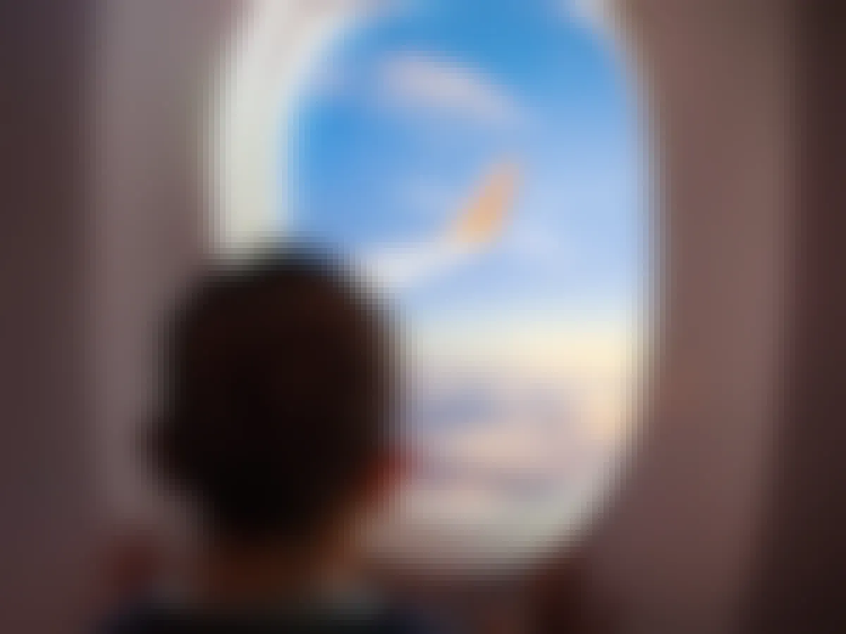 a child looking out of an airplane window