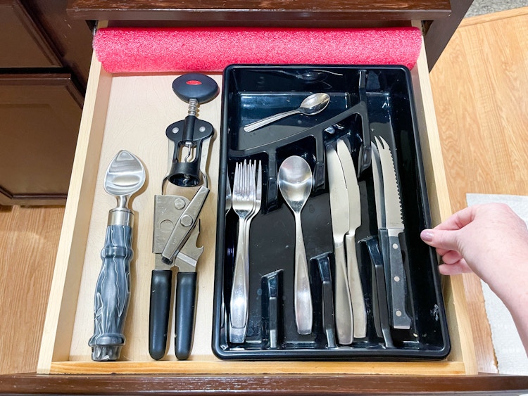 a pool noodle used to help with holding the silverware tray 