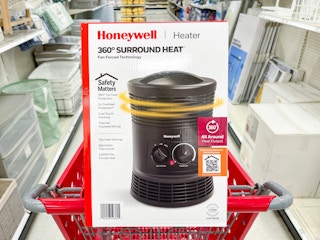 A Honeywell heater sitting in a shopping cart.