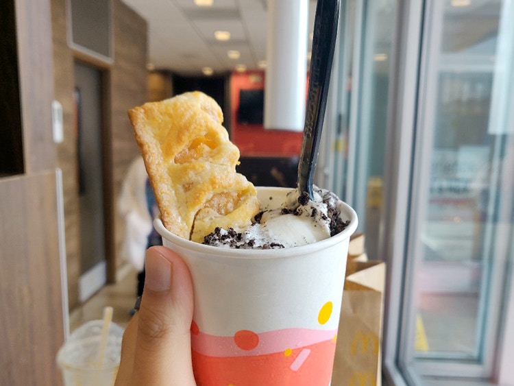 person holding mcflurry with mccafe apple pie added