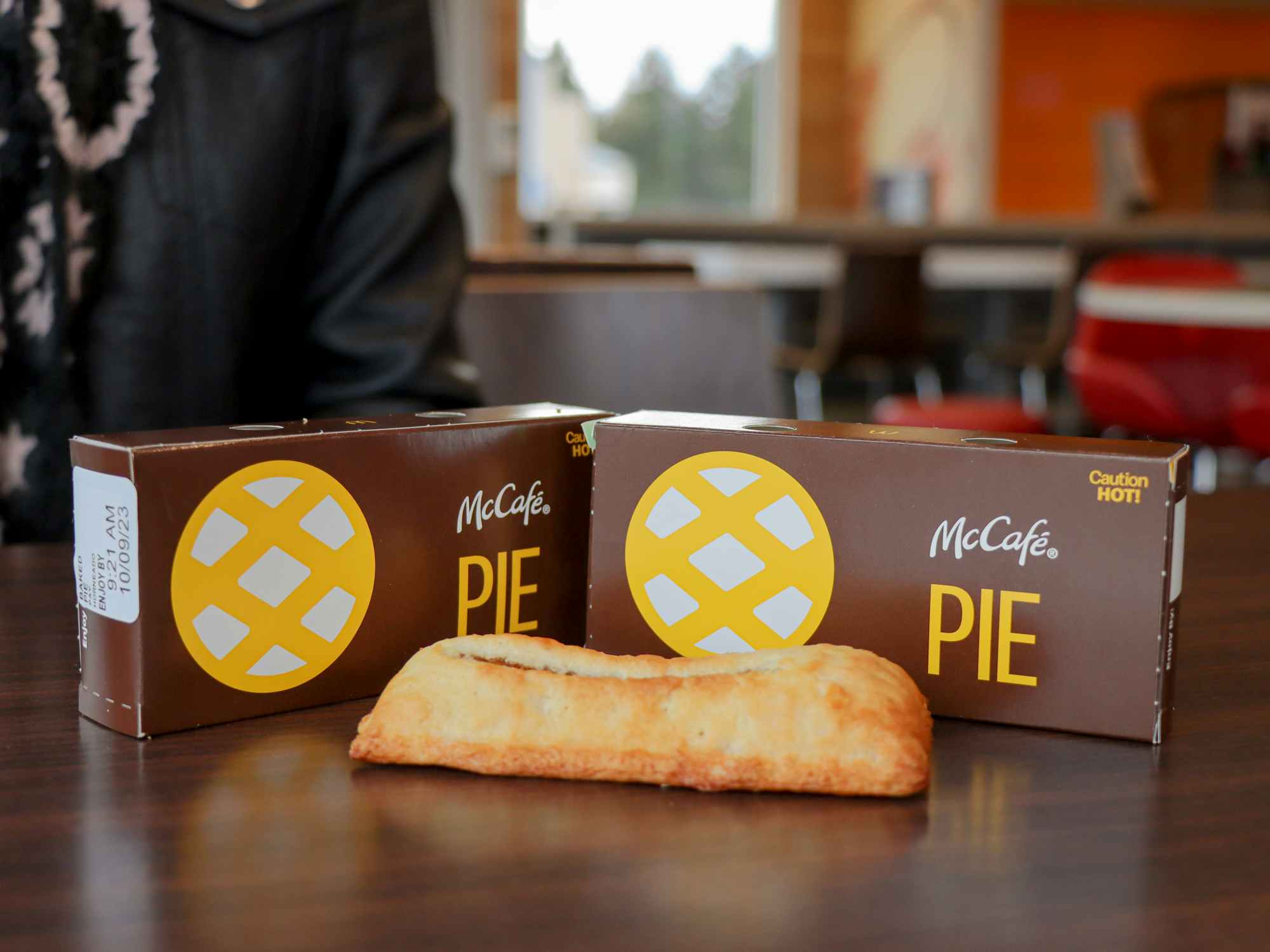 two mcdonalds pies sitting on a table 