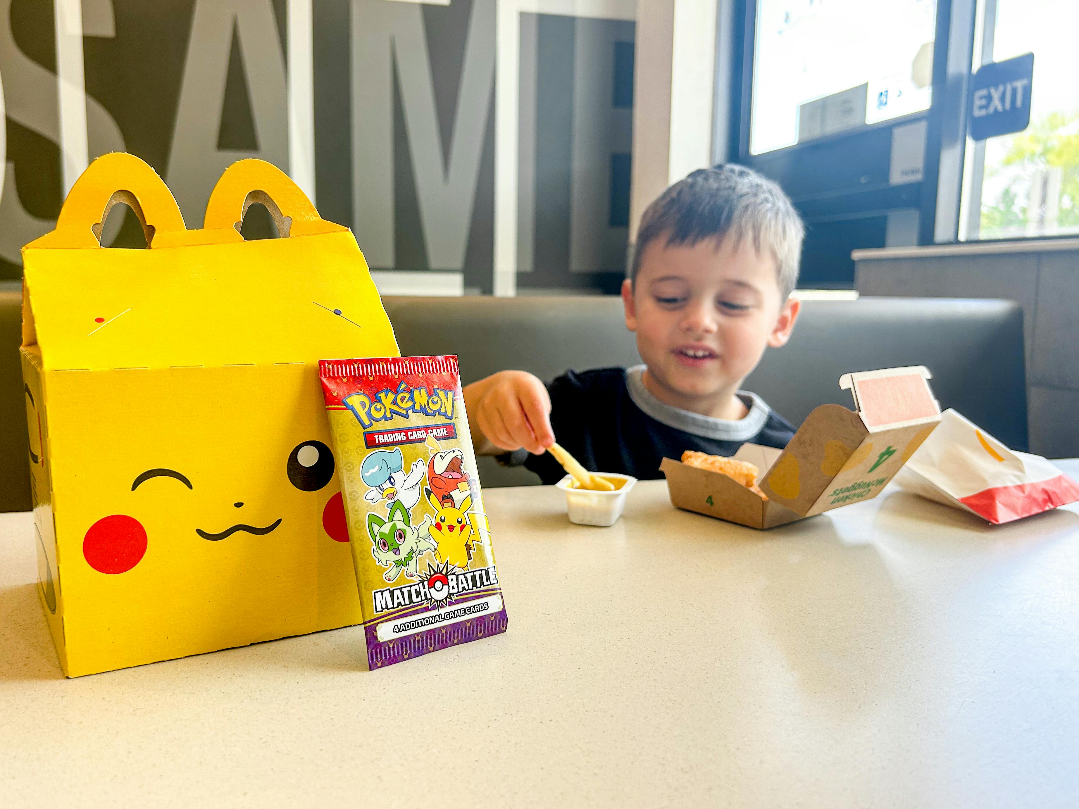 a child eating a happy meal at mcdonalds