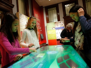 A group of children looking at an interactive exhibition