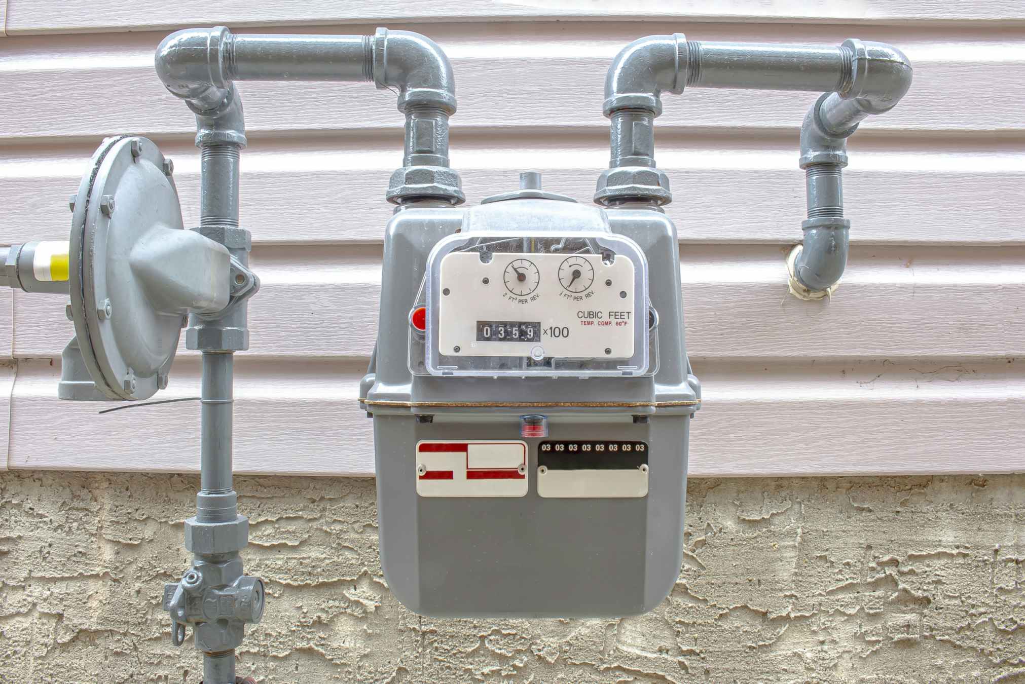 a natural gas meter on the outside of a house