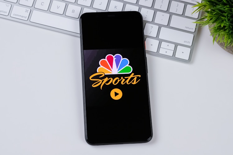 NBC sports on iphone on a computer desk