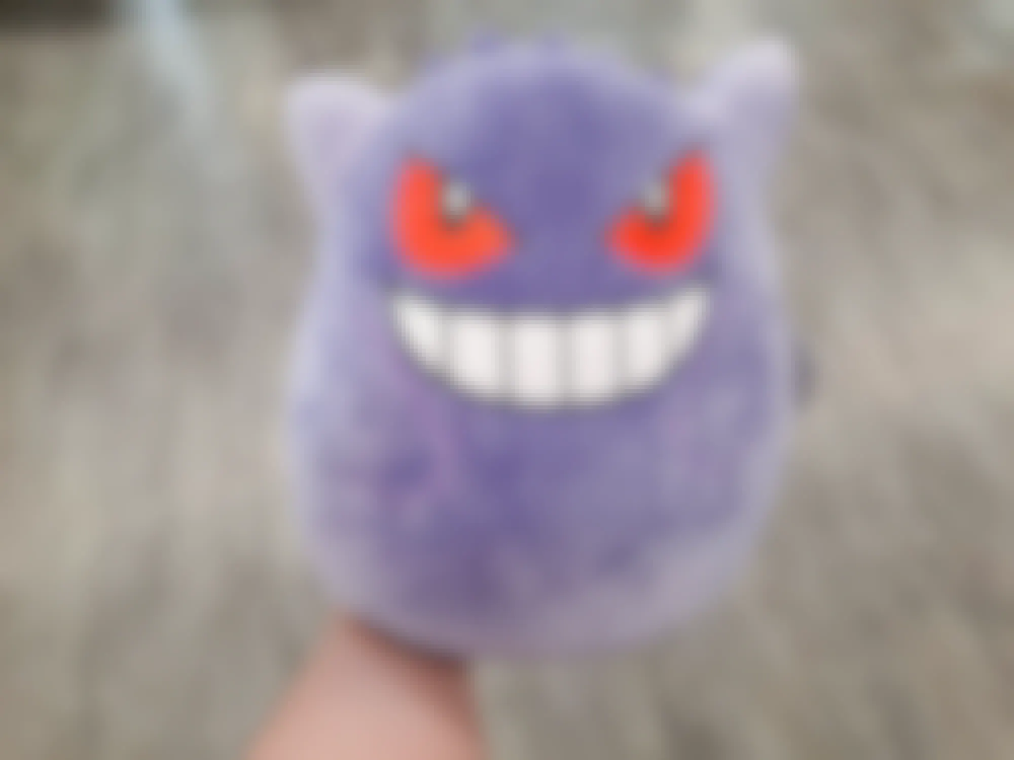 a person holding up a pokemon suishmallow