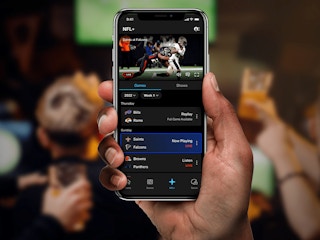 Person holding up a smart phone that has the NFL app in a large crowd