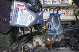 Pouring oil into a car