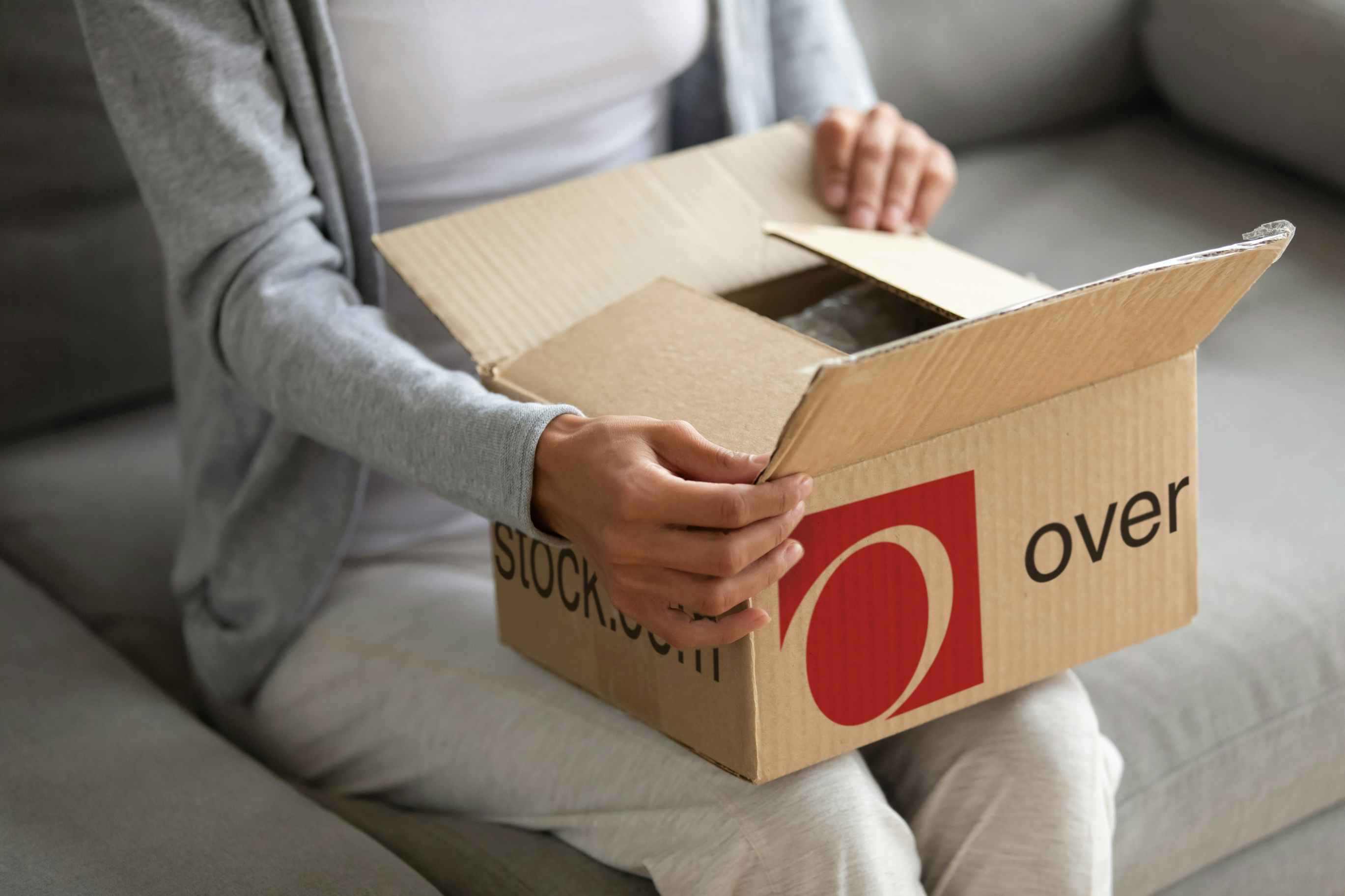 Someone opening a package from Overstock.com