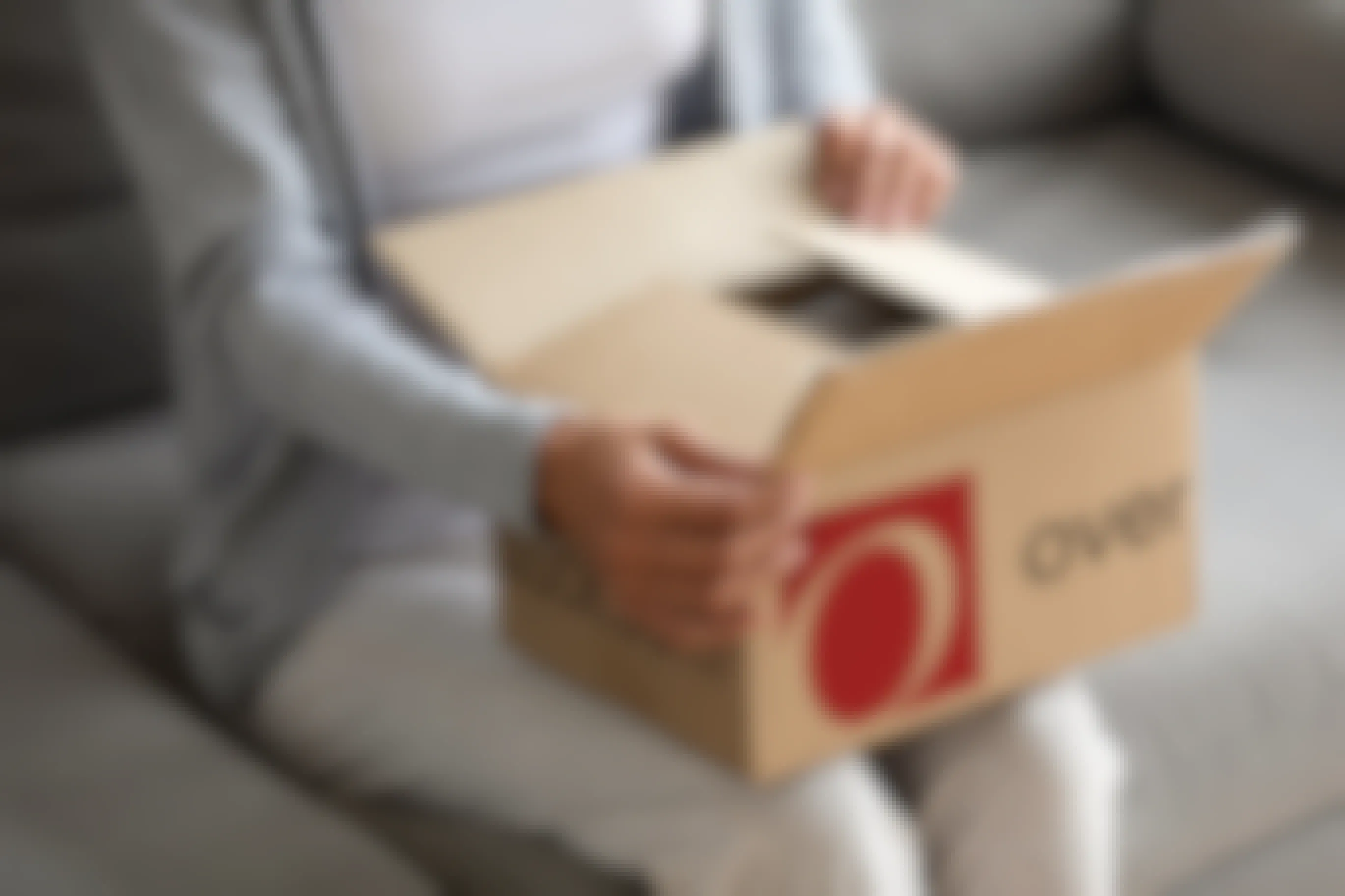 Someone opening a package from Overstock.com