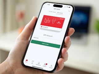 Someone adding an Overstock gift card to their shopping cart on the Overstock app