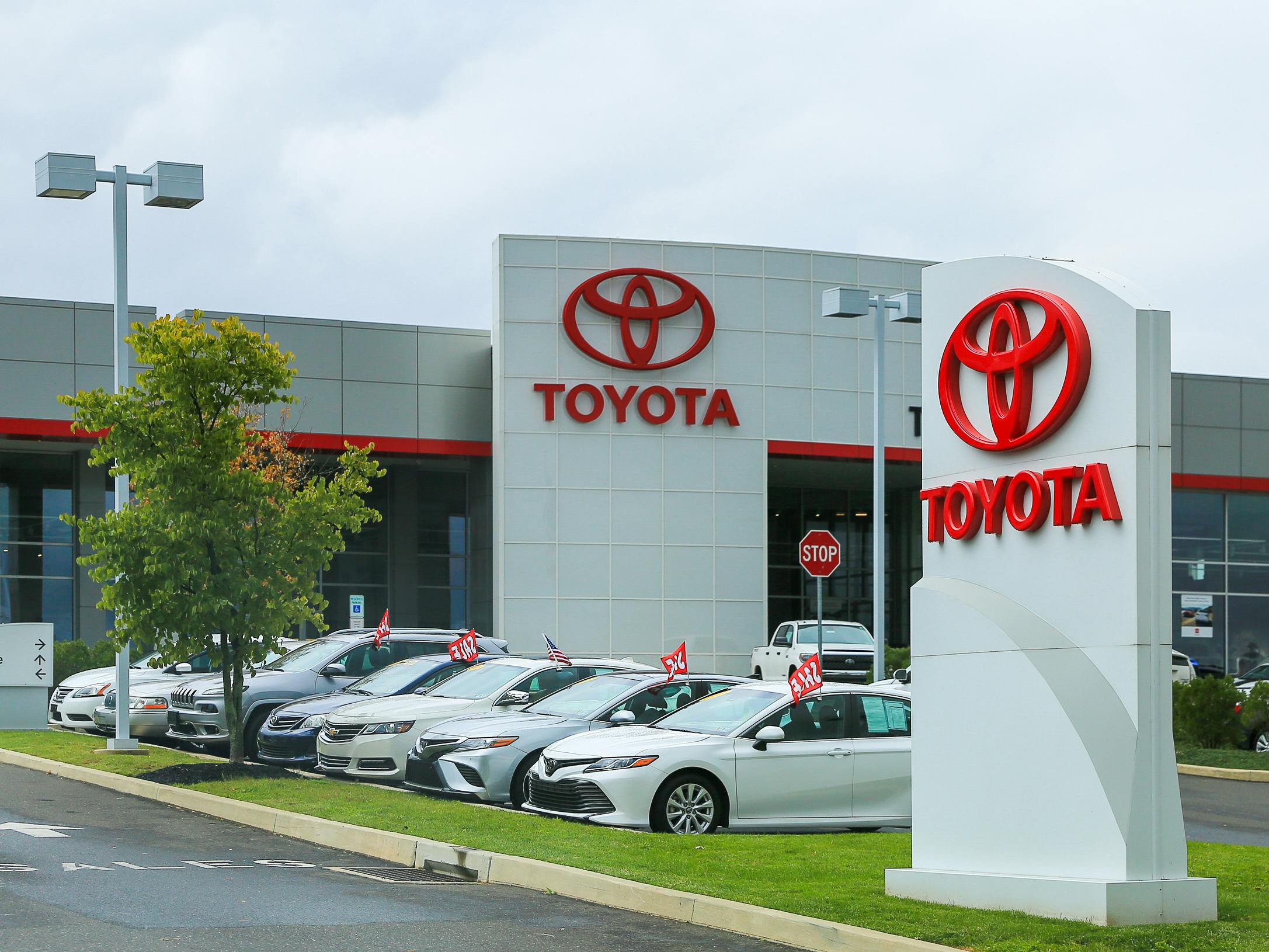 The front lot of a Toyota dealership with signs