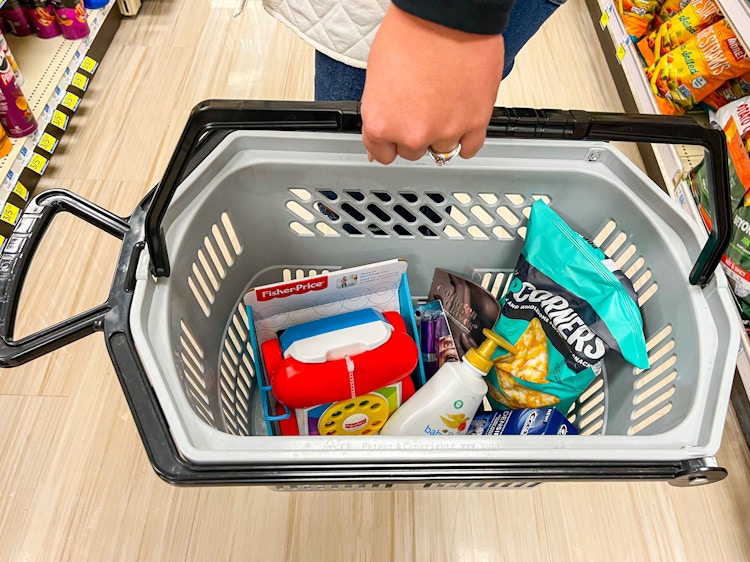 person holding a shopping basket at rite aid