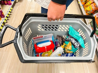 person holding a shopping basket at rite aid