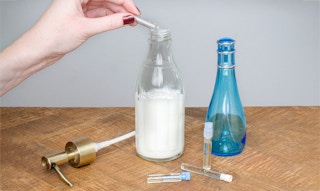 adding drops of perfume to body lotion container