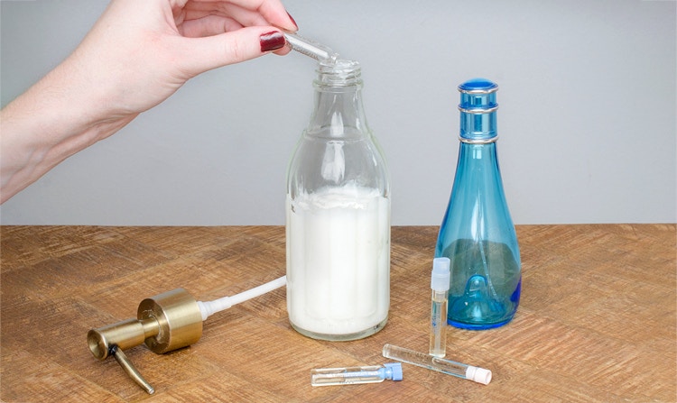 adding drops of perfume to body lotion container