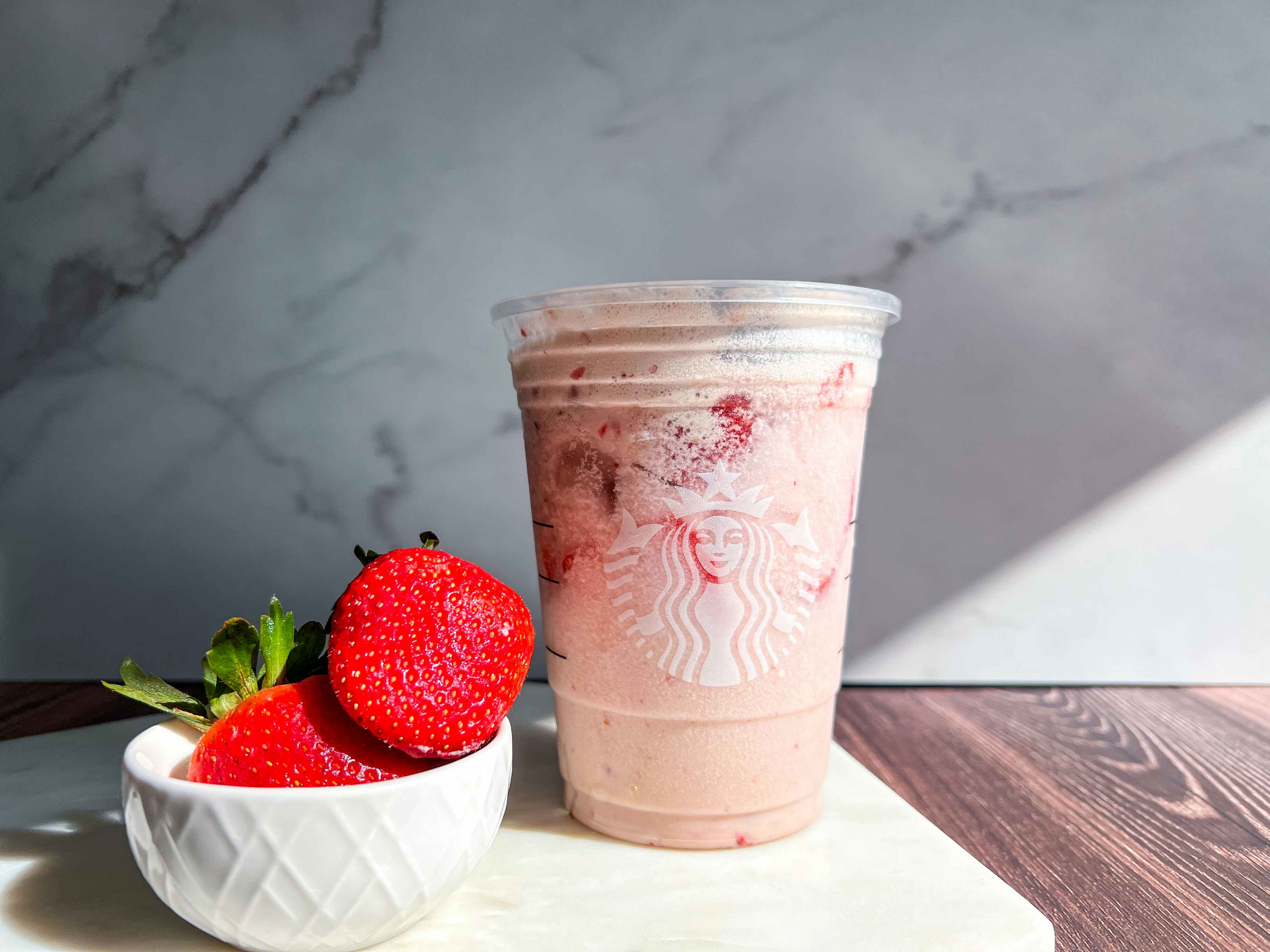 Starbucks new valentines day drink with two strawberries in a bowl