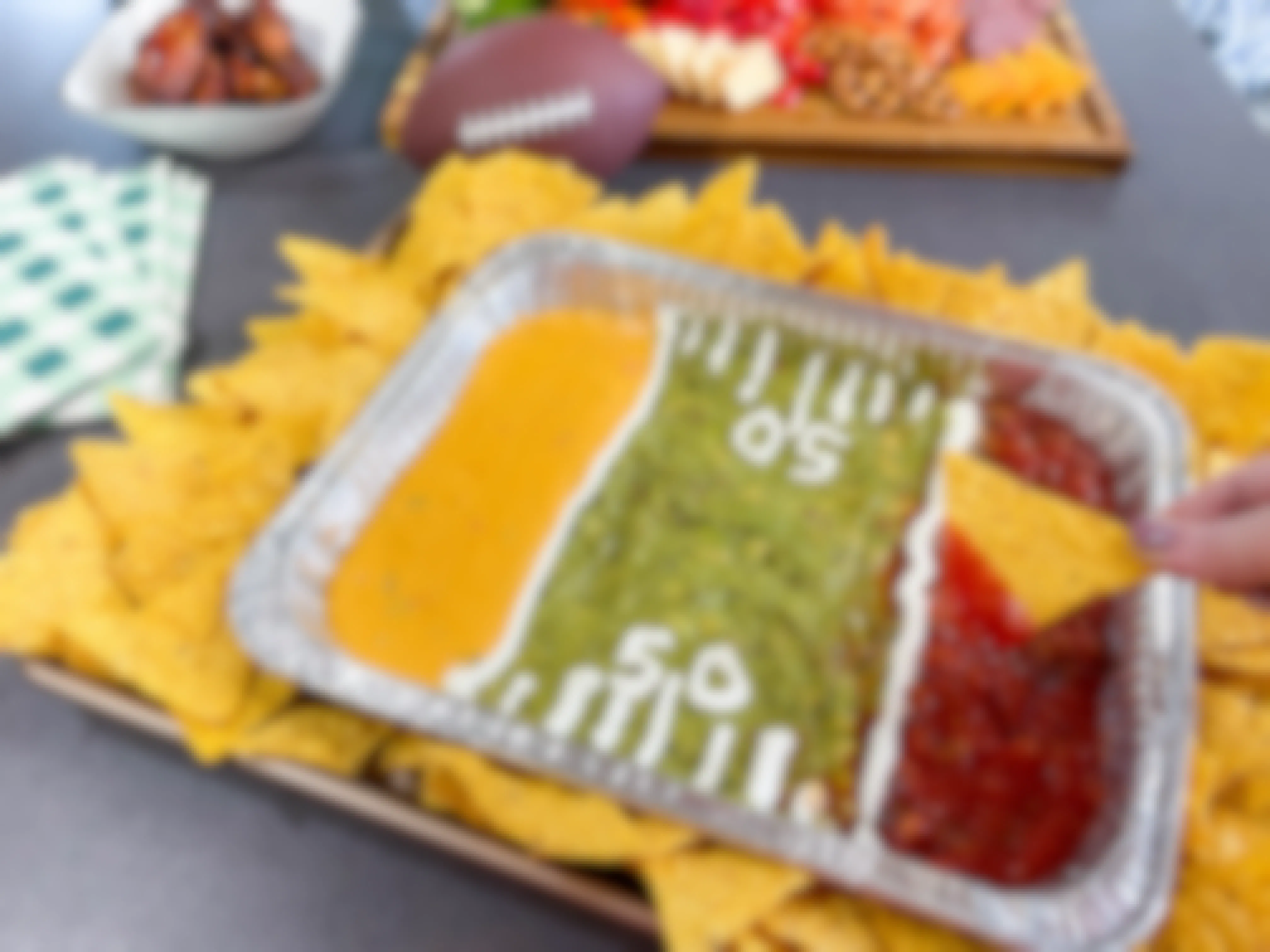 a tray of dips made into a football field 