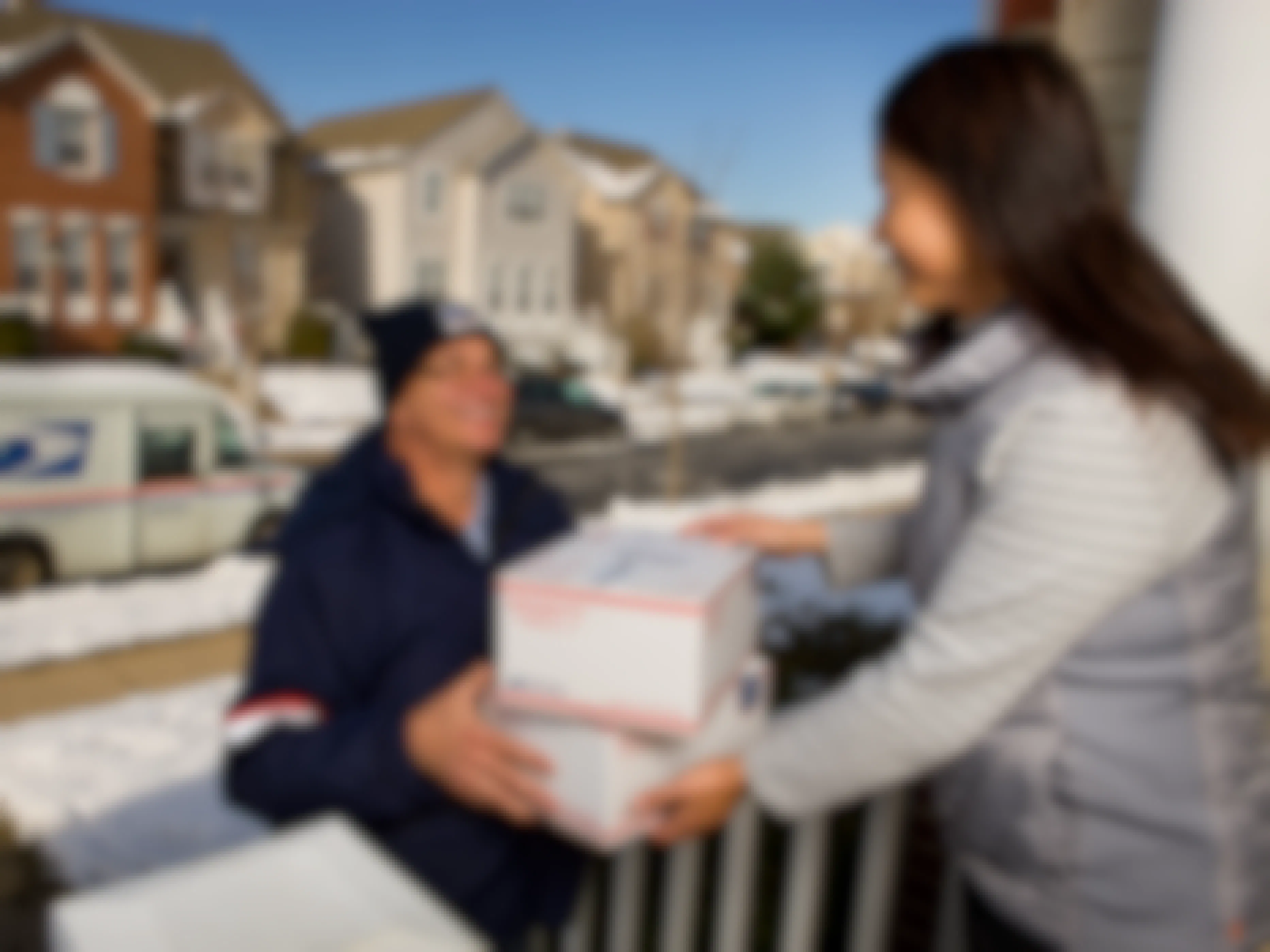A USPS Driver delivering packages to a person at their house