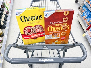 shopping cart with two boxes of General Mills Cheerios cereal inside