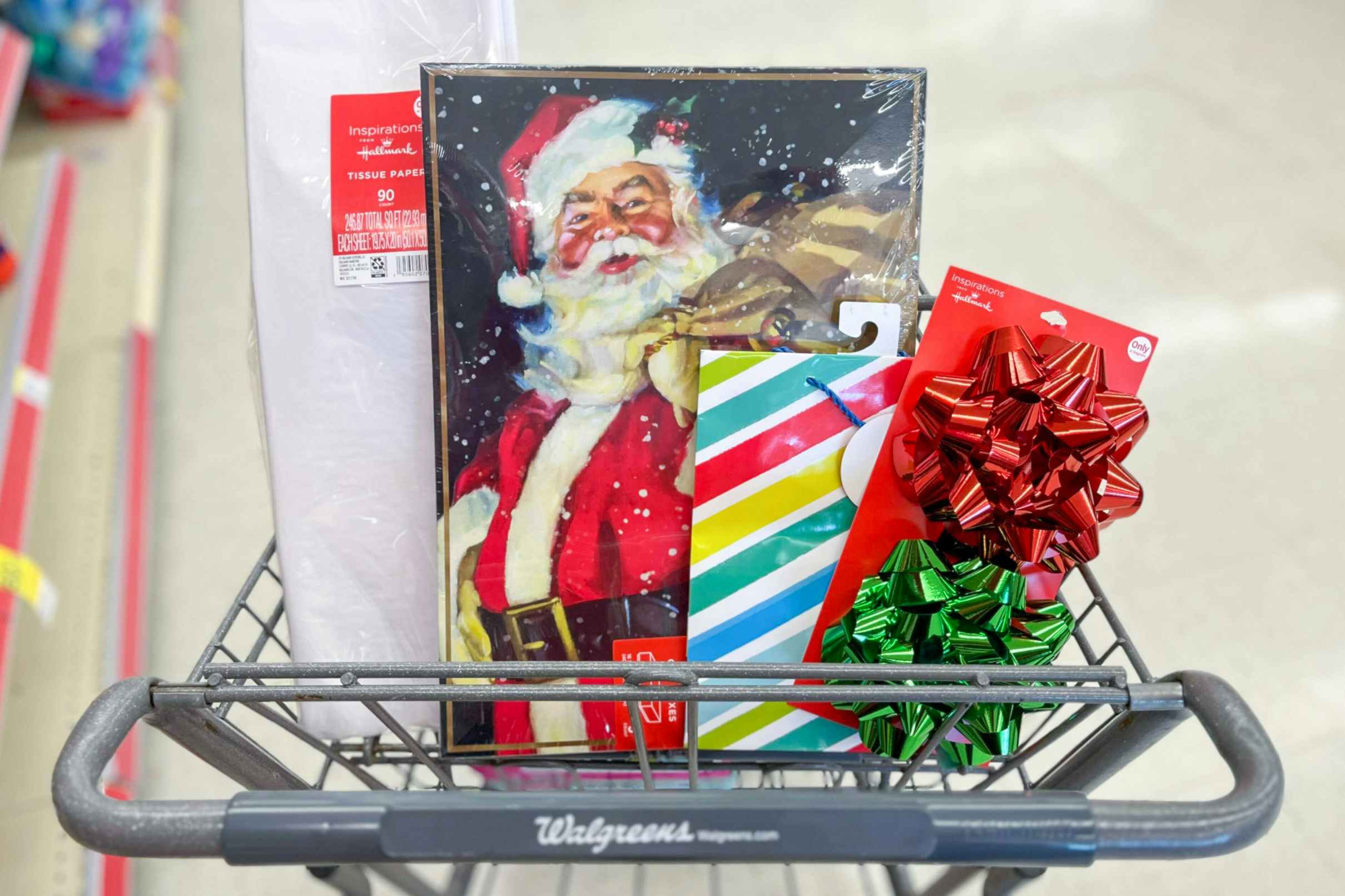 shopping cart with tissue paper, Santa gift boxes, gift bag, and bows inside